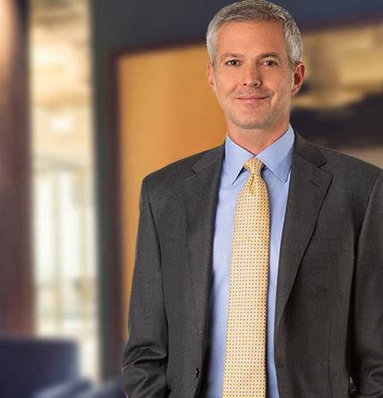 An image of Steve Fields in a suit smiling standing.